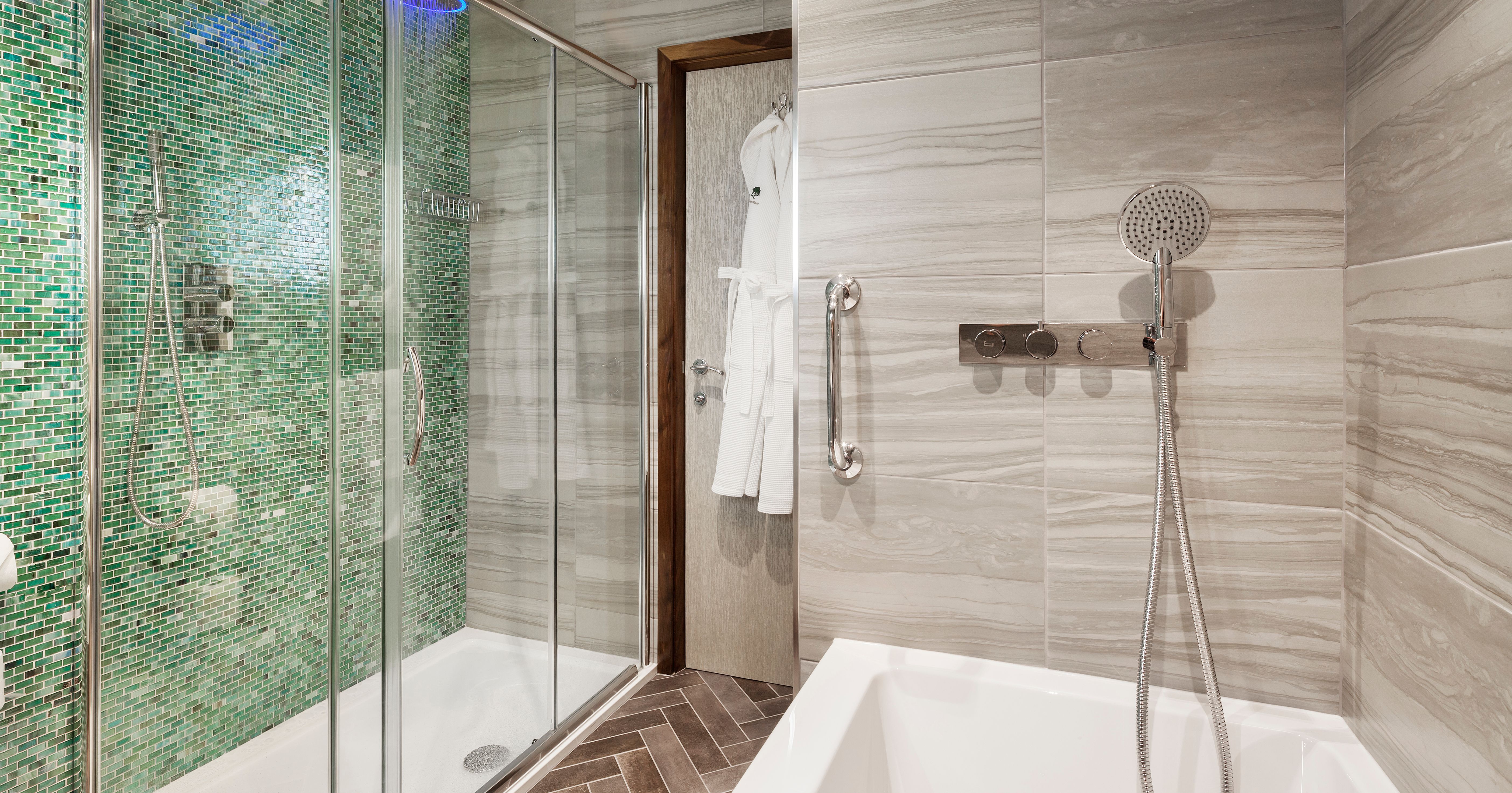 Modern ensuite bathroom with green mosaic tile shower and bathtub
