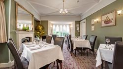 Elegant restaurant dining room with tables set for service
