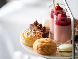 Assorted elegant pastries and desserts on a tiered serving tray