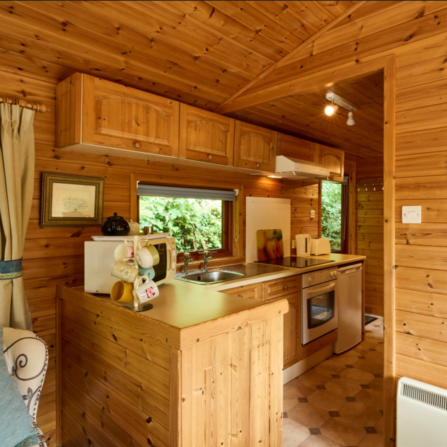 Cozy wooden cabin kitchen interior with natural light and rustic decor