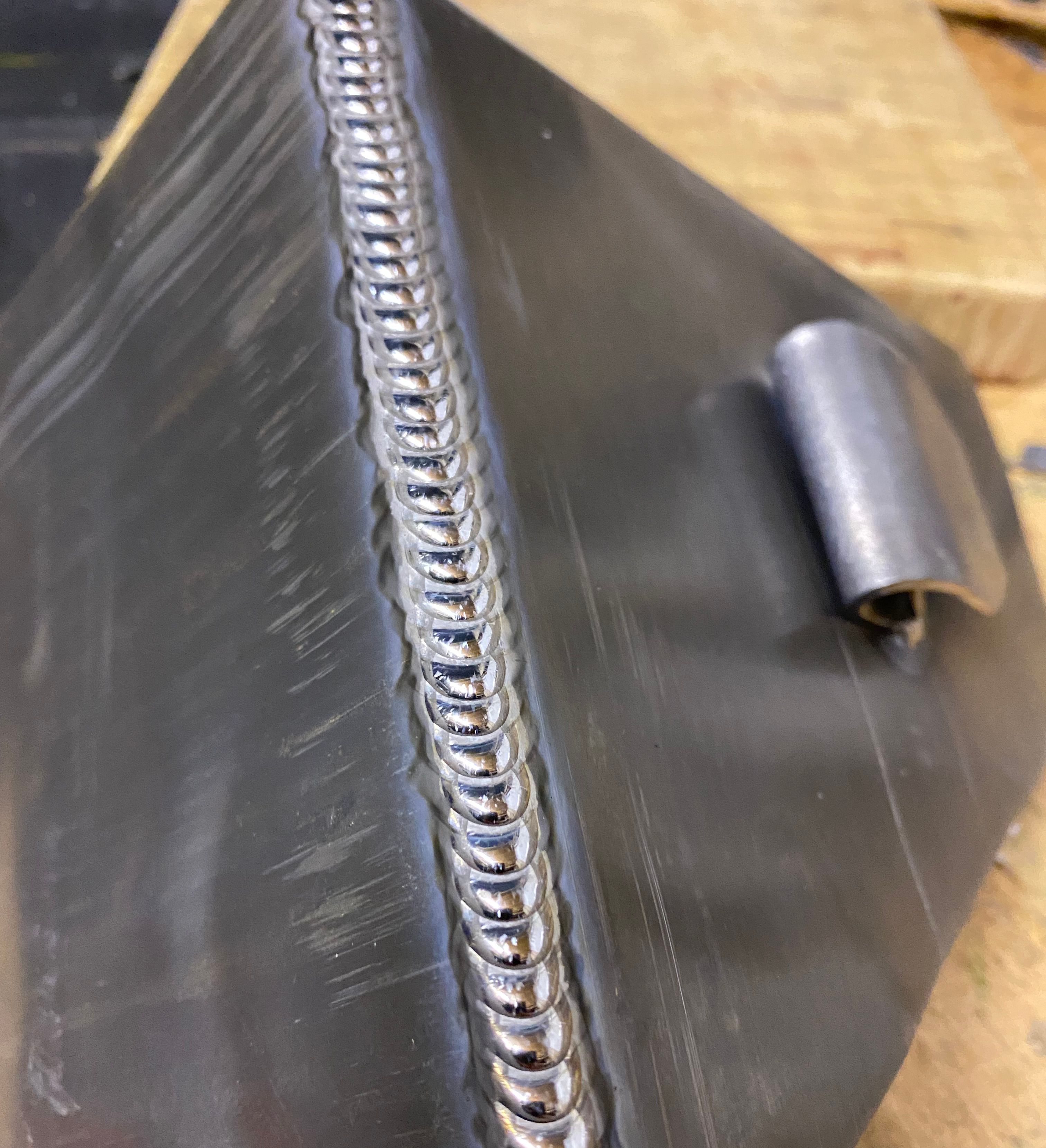 Close-up of a metal surface with a clean and precise weld bead.