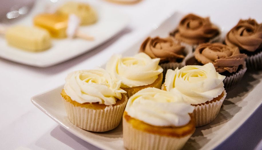 Assorted cupcakes with white and chocolate buttercream on a serving platter