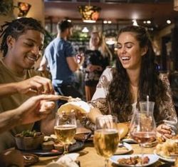 Group of friends enjoying dinner and drinks at a restaurant