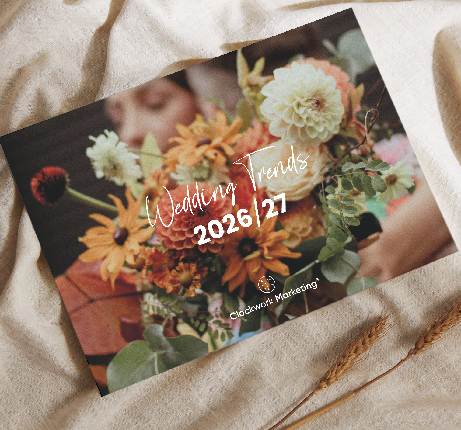 Wedding Trends 2026/27 magazine cover with a bouquet of orange, white, and yellow flowers on a fabric background.