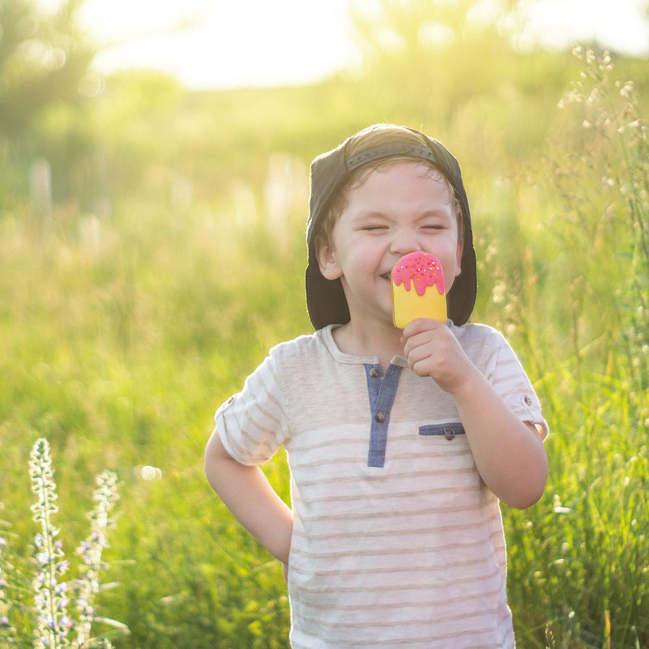Boy eating ice cream in field
