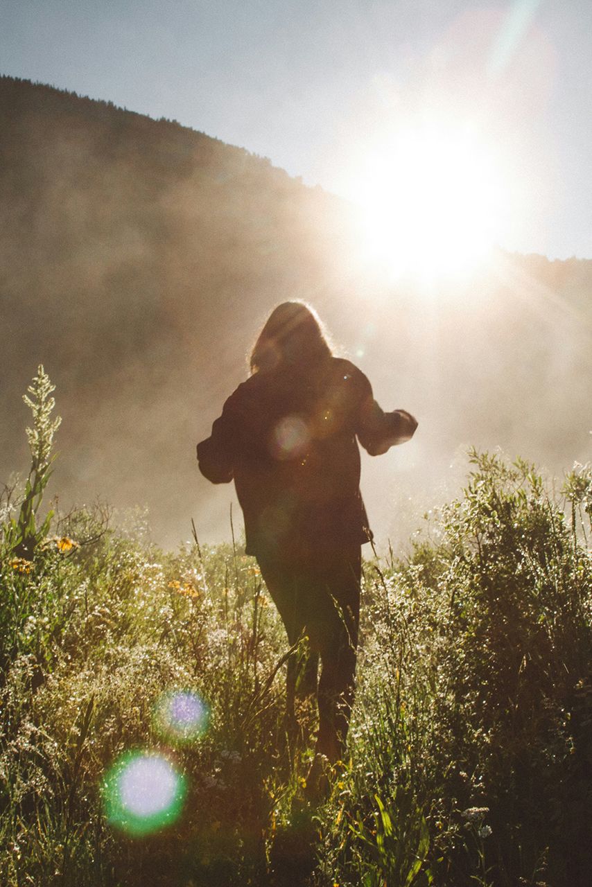 Woman running through field