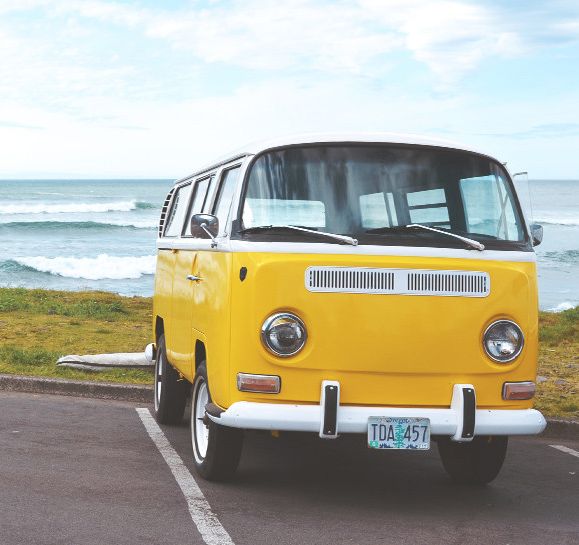 Yellow camper van by the sea