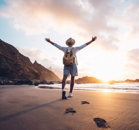 man on beach at sunrise