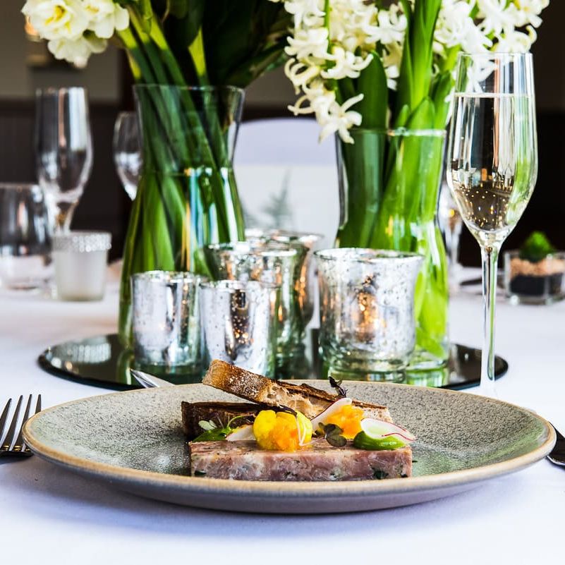 Elegant wedding table setting with gourmet plated food and champagne