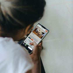 Person browsing a property listing on a smartphone