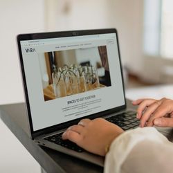 Person using a laptop while browsing the VARA website