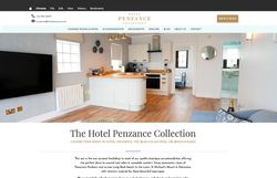 Modern hotel suite with kitchen, living area, and visible bedroom and bathroom at Hotel Penzance Collection.