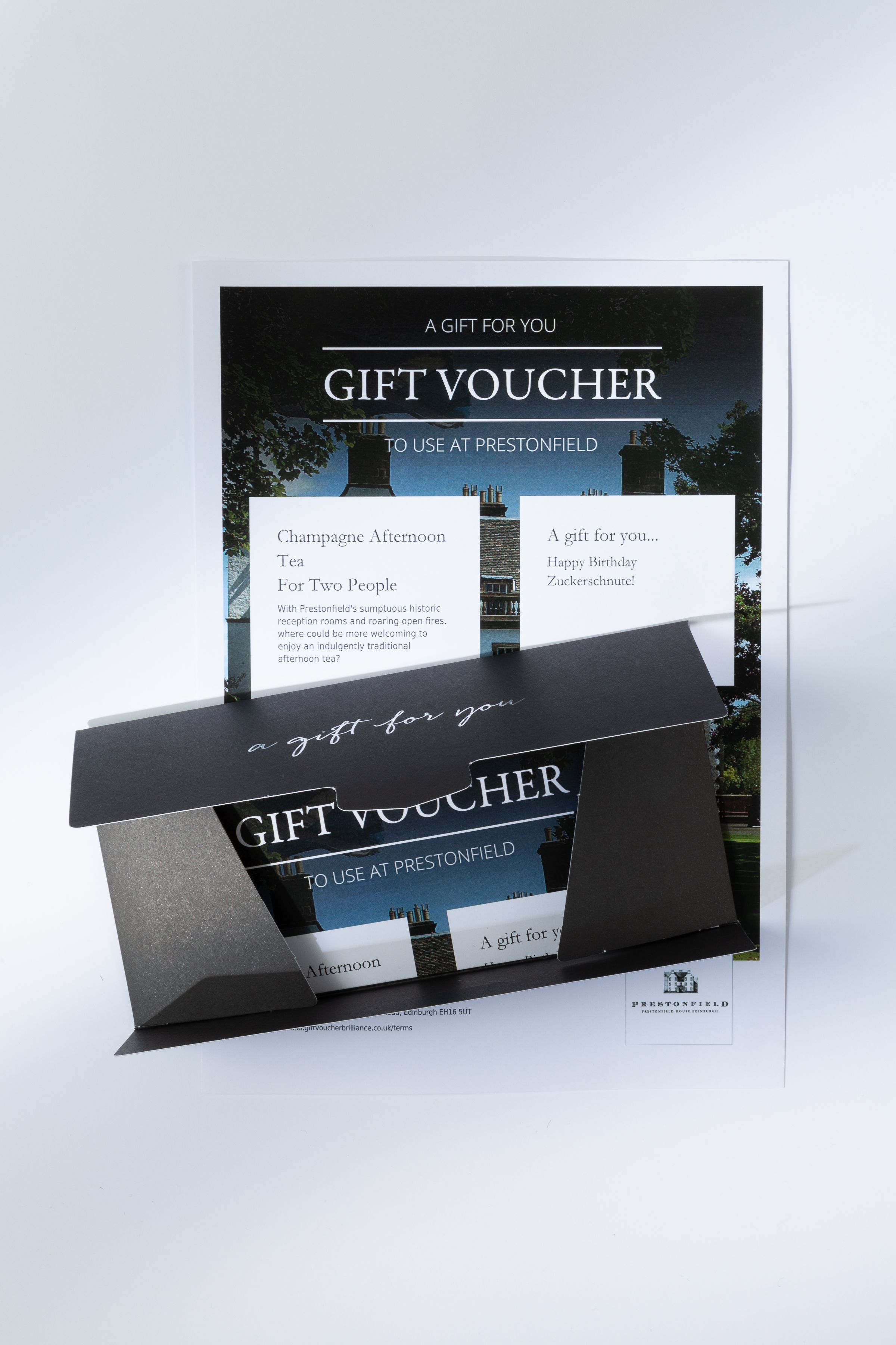 Gift voucher for Champagne Afternoon Tea at Prestonfield, presented in a black envelope.