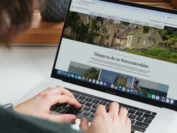 Person using a laptop to browse the Wood Norton website about things to do in Worcestershire.