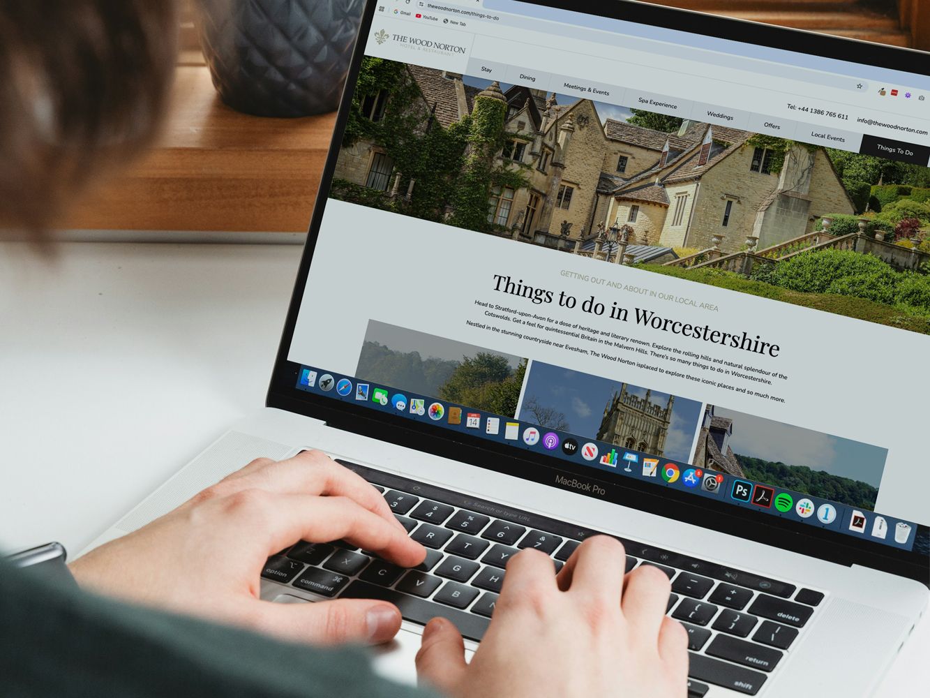 Person using a laptop to browse the Wood Norton website about things to do in Worcestershire.