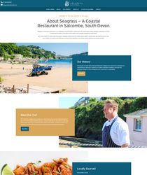 Seagrass coastal restaurant webpage featuring images of a beach, a chef, and seafood dishes.
