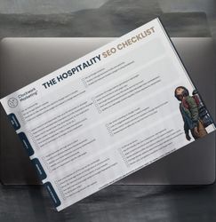 Printed hospitality SEO checklist on a laptop