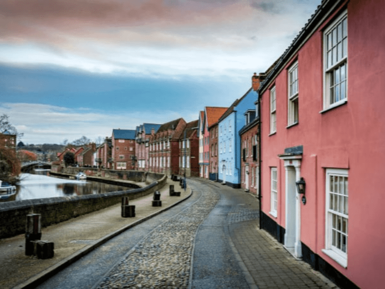 Colorful houses along a riverside street in Norwich