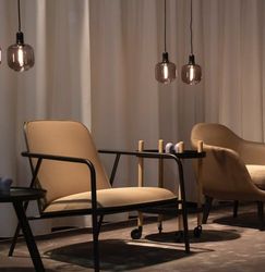 Modern lounge area with beige armchairs and pendant lights