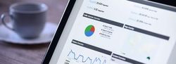 Tablet screen displaying website analytics dashboard with charts and graphs