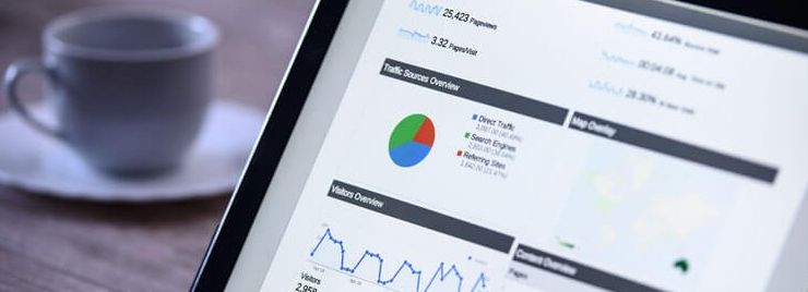 Tablet screen displaying website analytics dashboard with charts and graphs