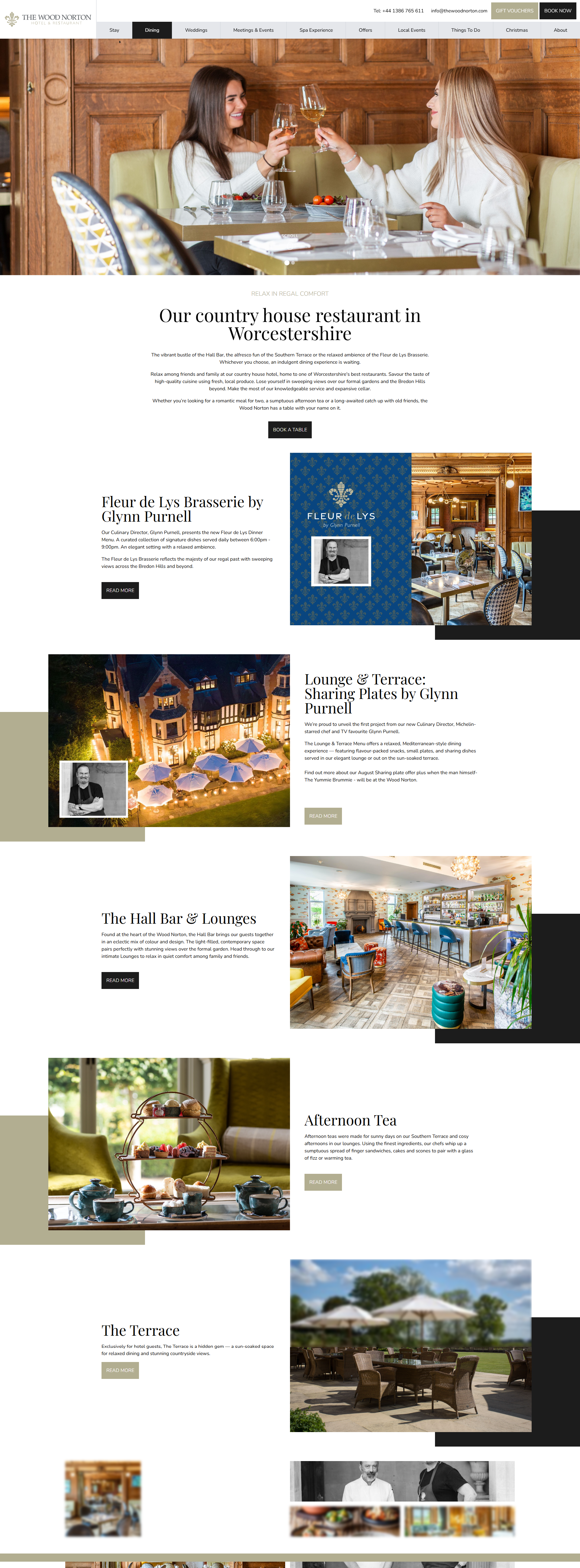Two women enjoying drinks at a restaurant table in an elegant wood-paneled room.
