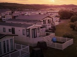 Row of modern mobile homes in a holiday park at sunset