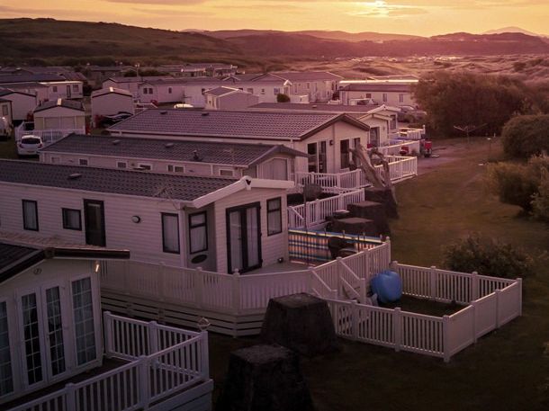 Row of modern mobile homes in a holiday park at sunset