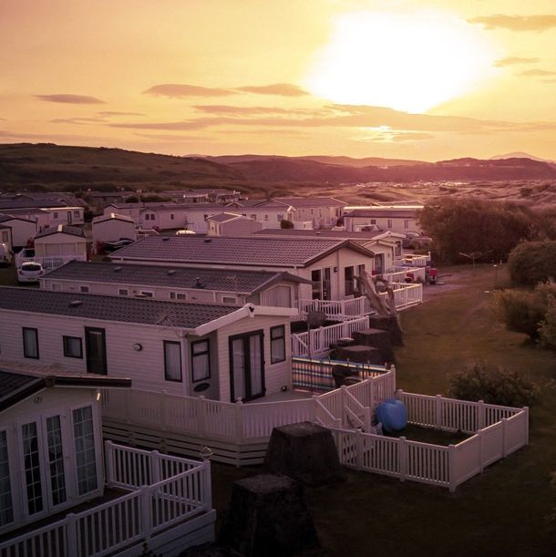 Row of modern mobile homes in a holiday park at sunset