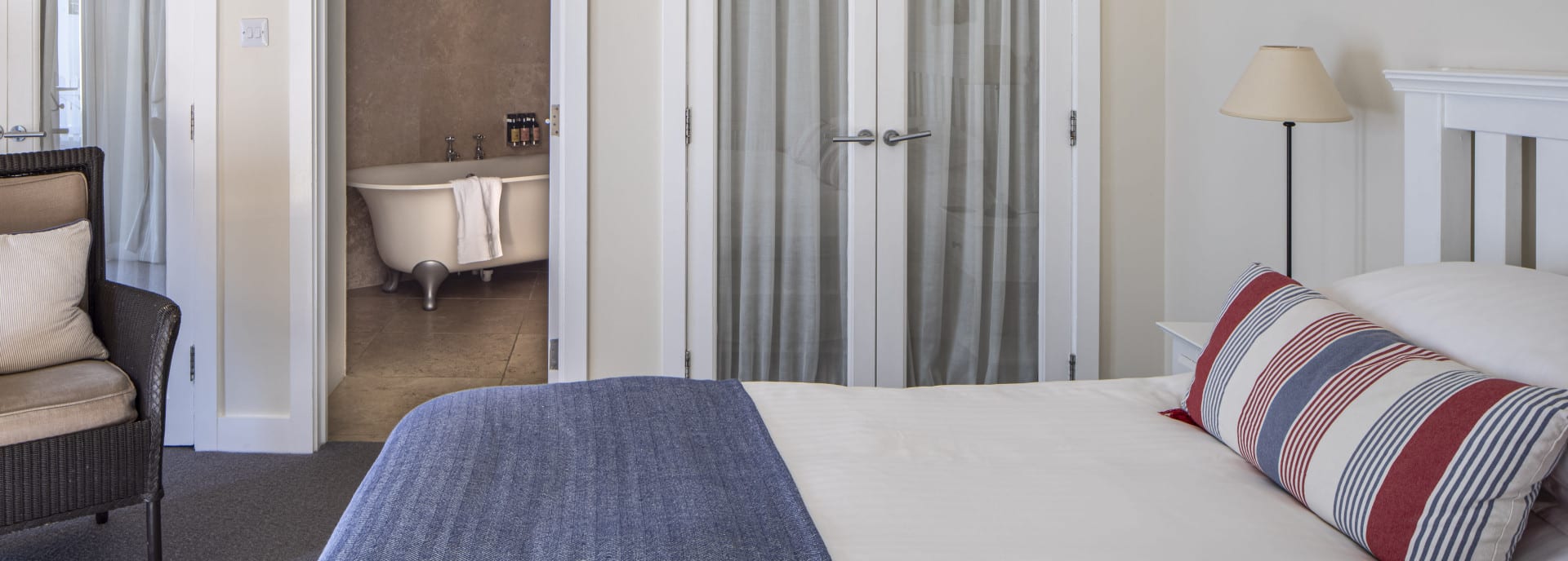 Luxury hotel bed and en suite bathroom