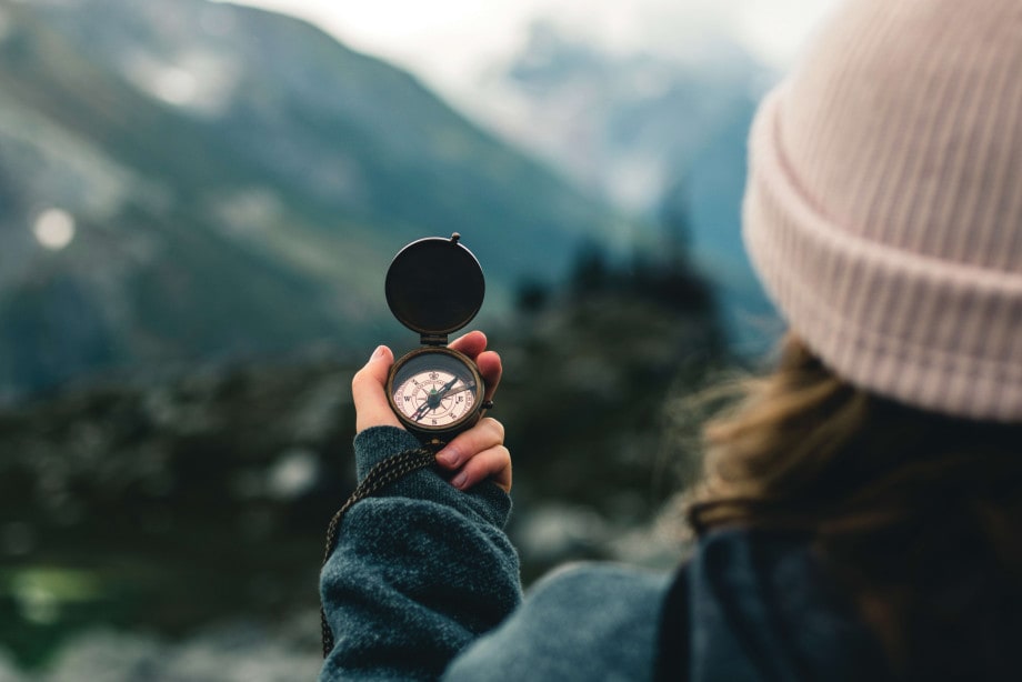 Woman holding up compass