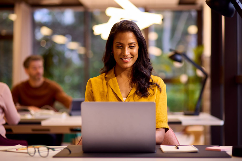 Woman smiling at her laptop