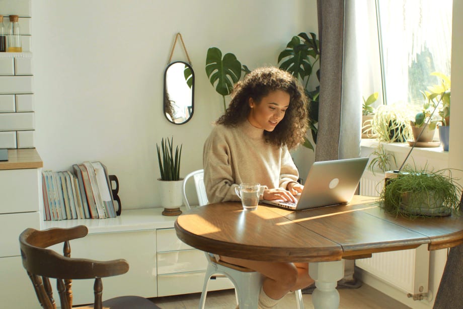 Lady on computer in house
