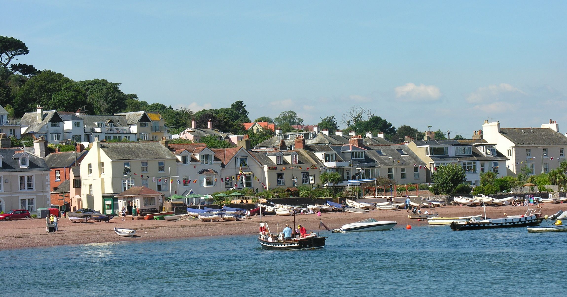 View of the River Teign at Shaldon with boats on the water and houses along the shoreline