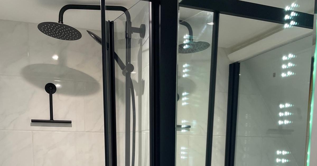 Modern bathroom with black fixtures and a glass shower enclosure