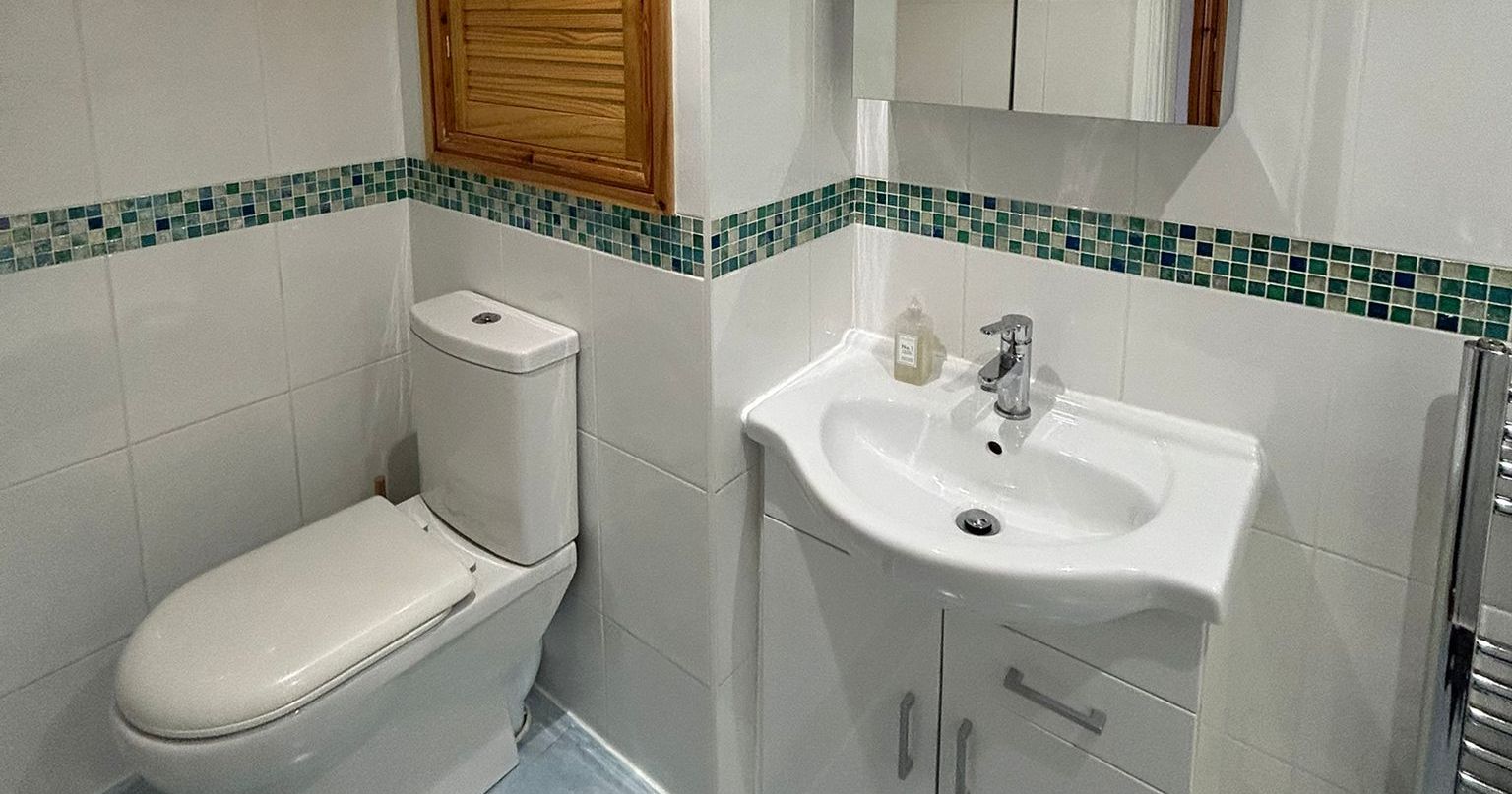 Modern bathroom with toilet and sink cabinet
