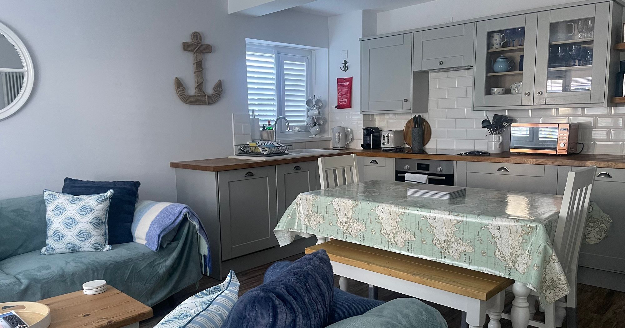 Cozy open-plan living room and kitchen with nautical decor