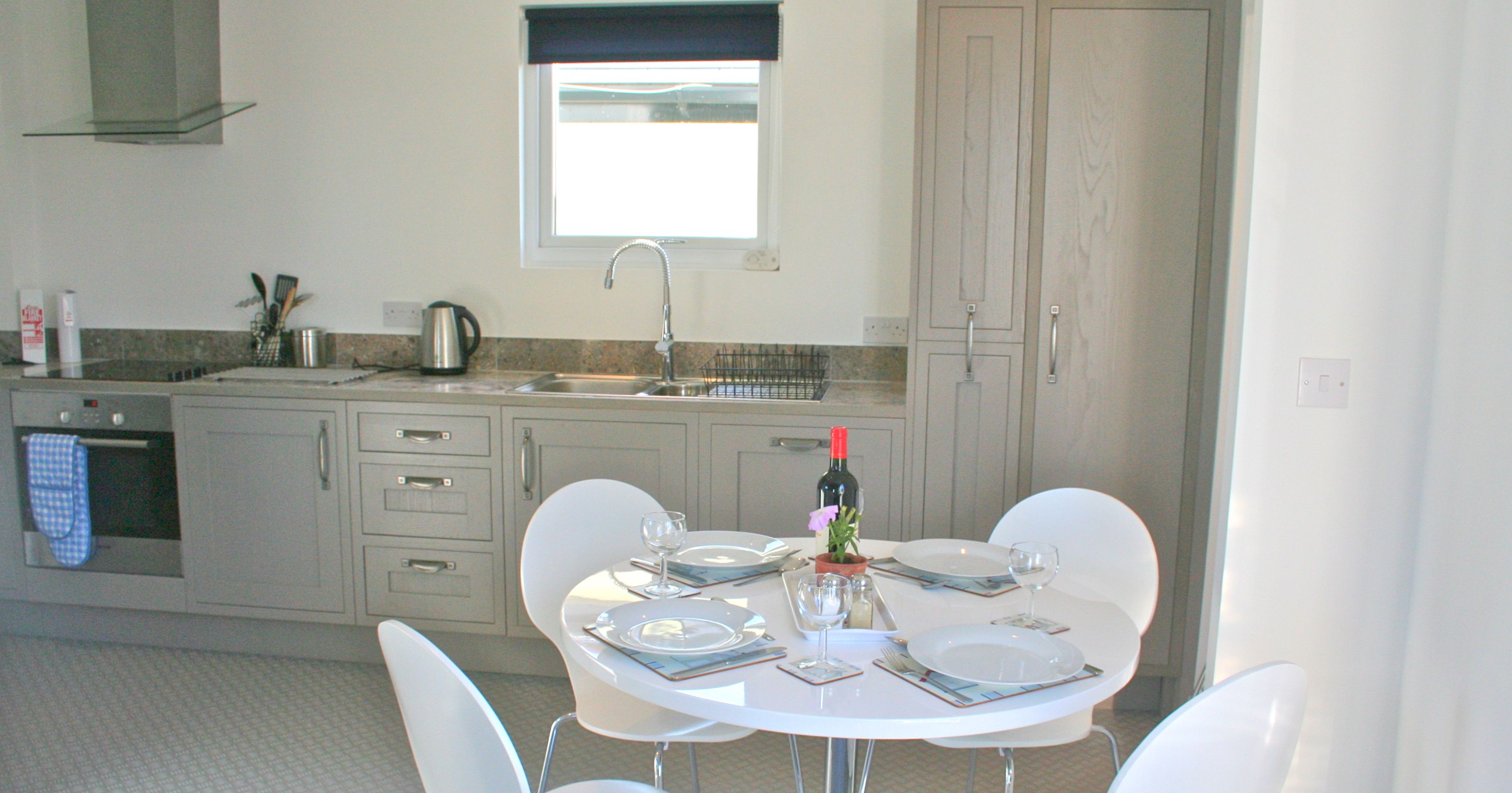 Modern kitchen with round dining table set for four