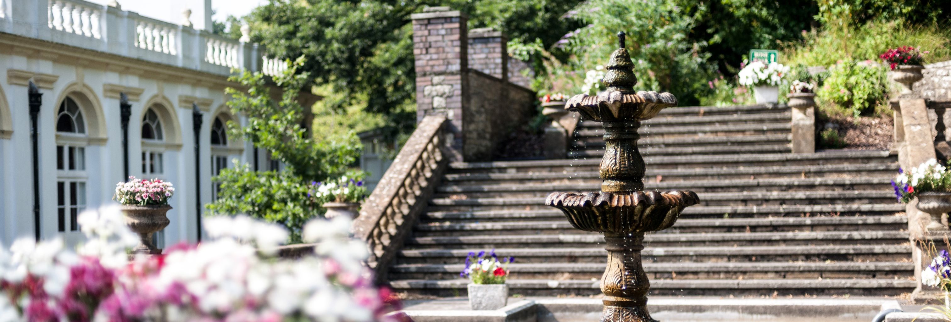 Fountain and flowers by exterior steps