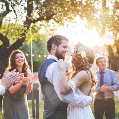 Couple dancing at their wedding on a sunny day