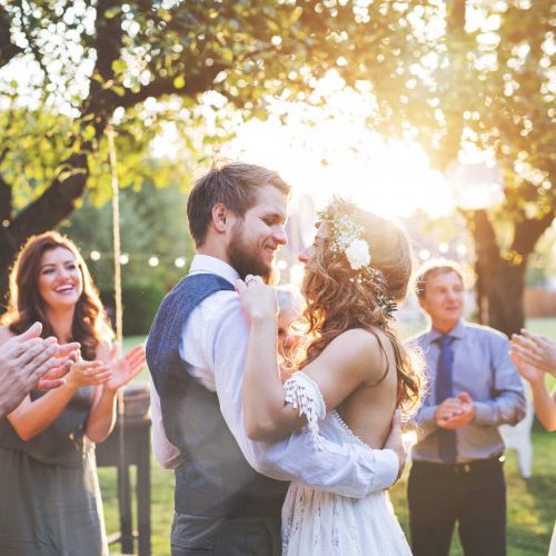 Couple dancing at their wedding on a sunny day