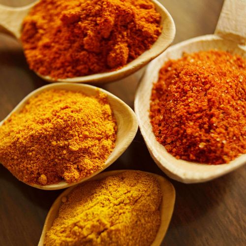 Orange and Yellow Spices on Spoons