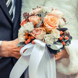 Bride and Groom holding a bouquet of flowers