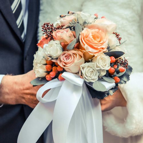 Bride and Groom holding a bouquet of flowers