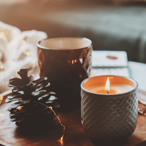 Candles lit on a wooden surface