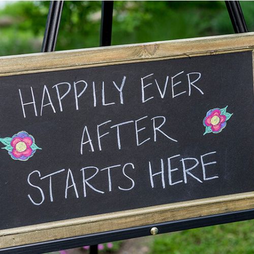 'Happily ever after starts here' chalkboard sign