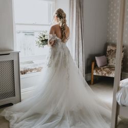 Bride in bedroom by window