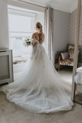 Bride in bedroom by window
