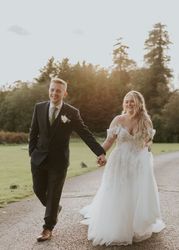 Bride and groom walking up driveway