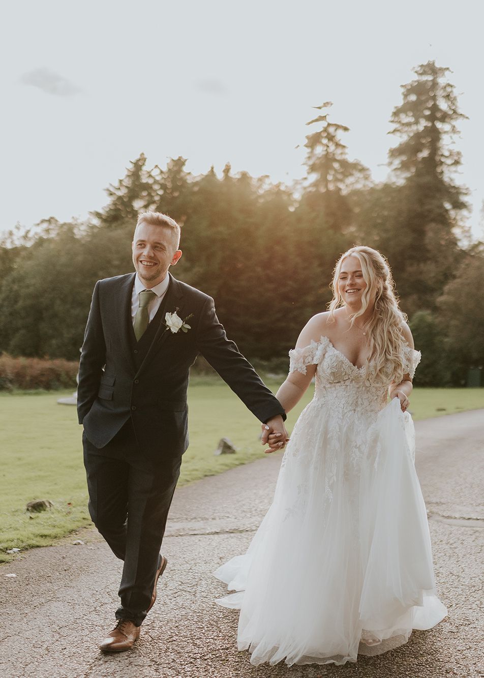 Bride and groom walking up driveway